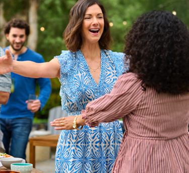 woman embracing a loved one at a pizza party